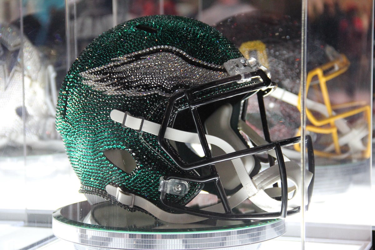 An up-close photo of a bejeweled Eagles helmet.