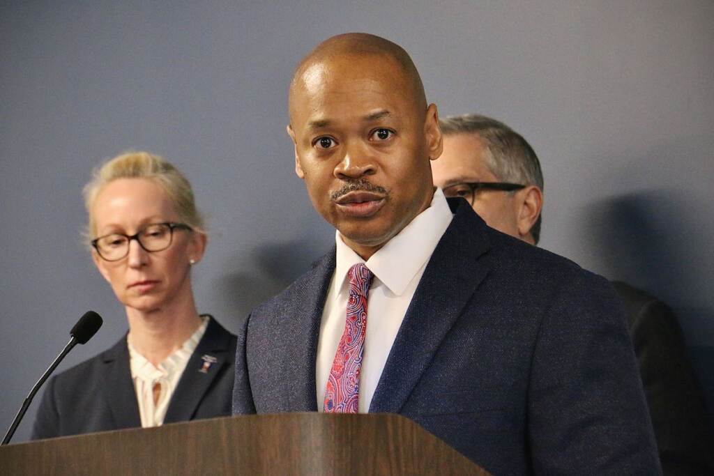 A close-up of Ernest Ransom speaking at a press conference.