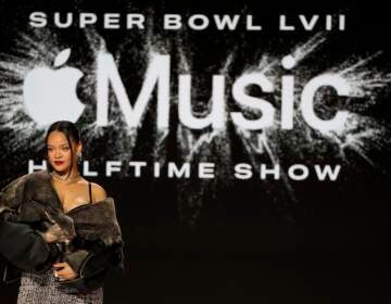 Rihanna poses for a photo after a halftime show news conference