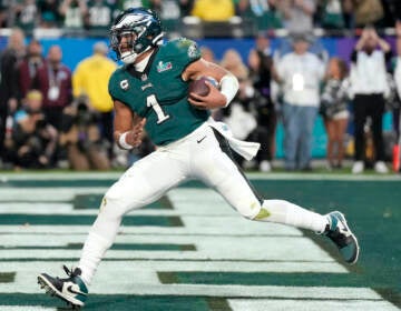 Philadelphia Eagles quarterback Jalen Hurts (1) runs into the end zone for a touchdown against the Kansas City Chiefs during the first half of the NFL Super Bowl 57 football game between the Kansas City Chiefs and the Philadelphia Eagles, Sunday, Feb. 12, 2023, in Glendale, Ariz. (AP Photo/Ashley Landis)