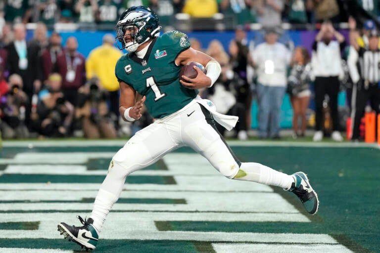 Philadelphia Eagles quarterback Jalen Hurts (1) runs into the end zone for a touchdown against the Kansas City Chiefs during the first half of the NFL Super Bowl 57 football game between the Kansas City Chiefs and the Philadelphia Eagles, Sunday, Feb. 12, 2023, in Glendale, Ariz. (AP Photo/Ashley Landis)