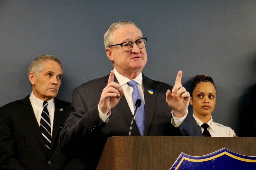 Mayor Kenney speaks into a microphone at a podium.