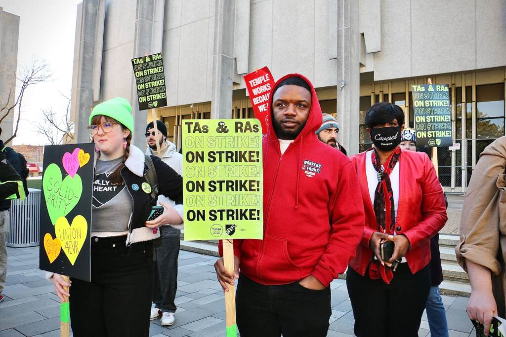 Temple University graduate students rally with signs.