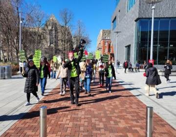 Striking grad student teachers walk on Temple's campus.