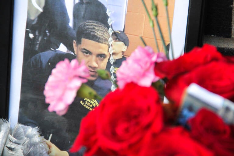 A photo of Christopher Fitzgerald placed a memorial set up next to the place he was killed, near 17th Street and Montgomery Avenue. (Cory Sharber/WHYY)