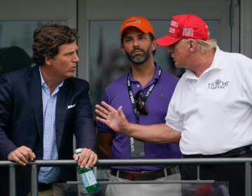 Tucker Carlson speaking with Donald Trump and Donald Trump Jr.