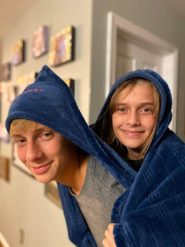 A brother and sister pose for a photo.