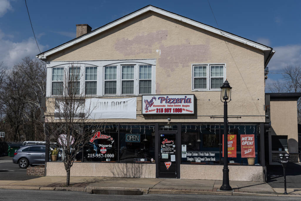 A building with a sign that reads "Amy's Pizzeria" is visible on a sunny day.