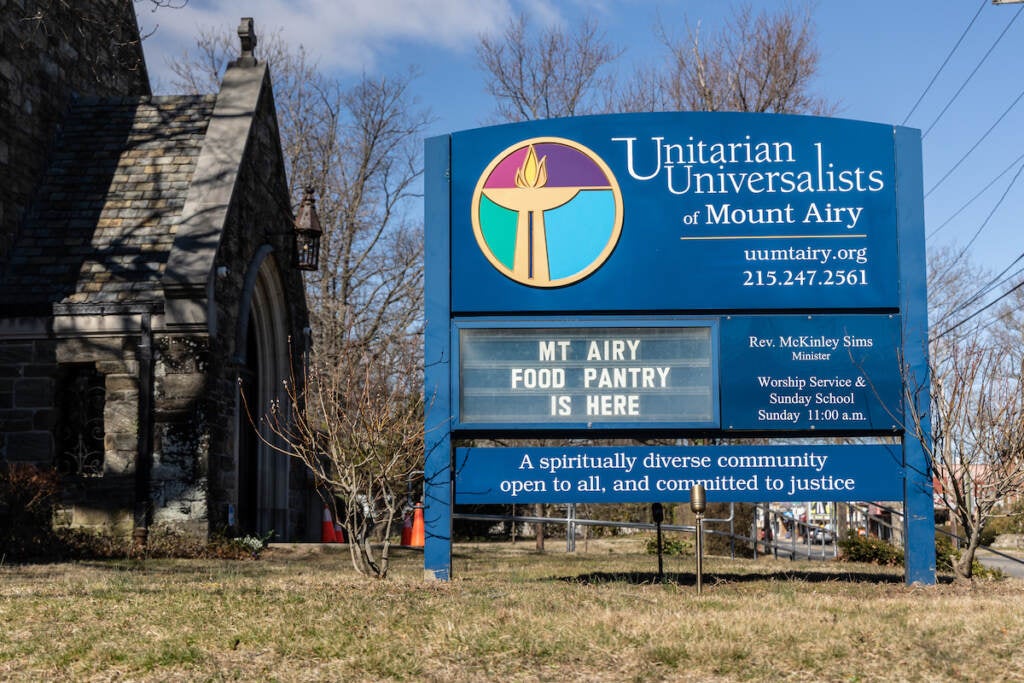 A sign outside of a church reads Unitarian Universalists of Mount Airy.