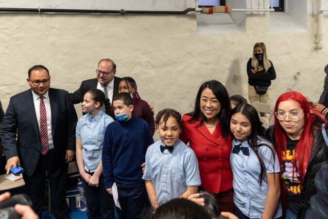 Philadelphia mayoral candidates Helen Gym and Alan Domb take photos with Gloria Casarez Elementary students after a forum