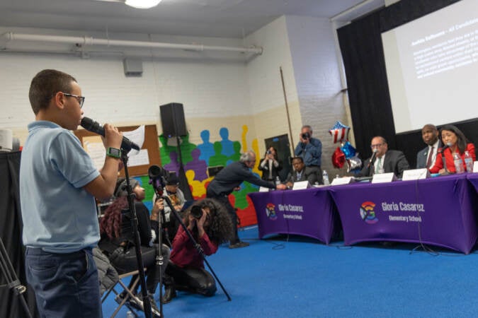 Jeremiah Rojas asks Philly mayoral candidates a question at a forum at Gloria Casarez Elementary