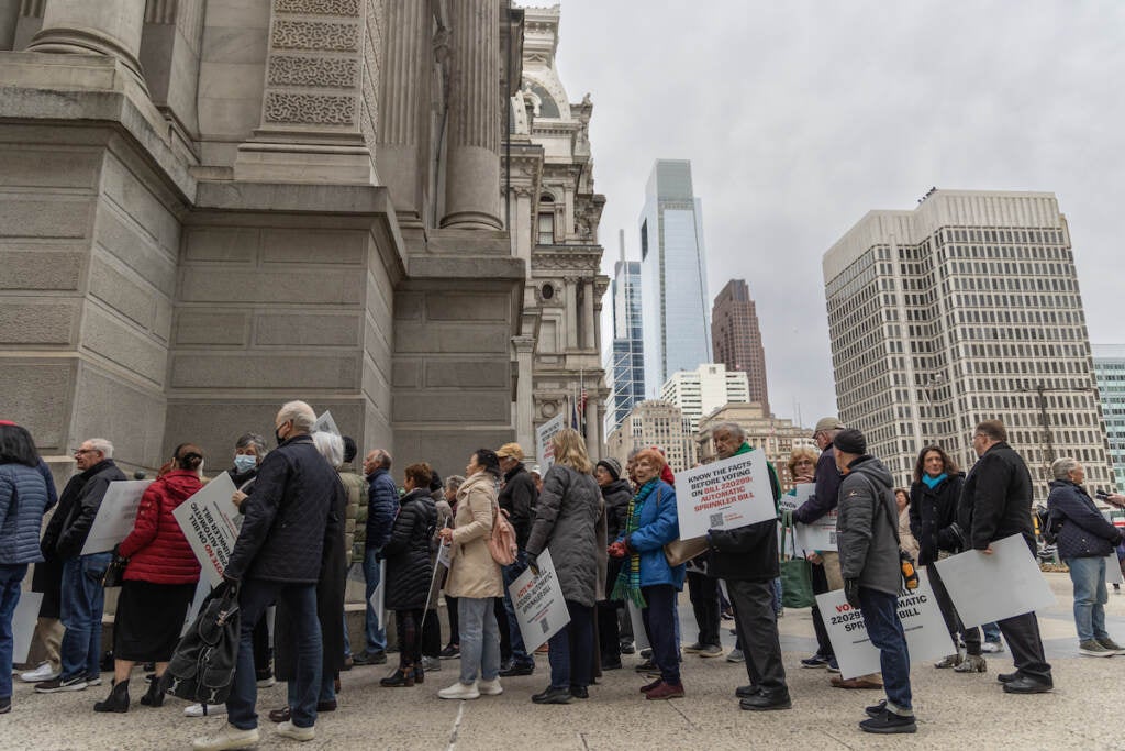 Apartment owners and residents protested outside City Hall against a council bill that would mandate automatic sprinklers systems in high-rise buildings ahead of a City Council session