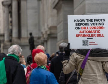 Apartment owners and residents protested outside City Hall against a council bill that would mandate automatic sprinklers systems in high-rise buildings ahead of a City Council session