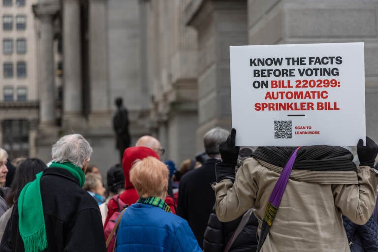 Apartment owners and residents protested outside City Hall against a council bill that would mandate automatic sprinklers systems in high-rise buildings ahead of a City Council session