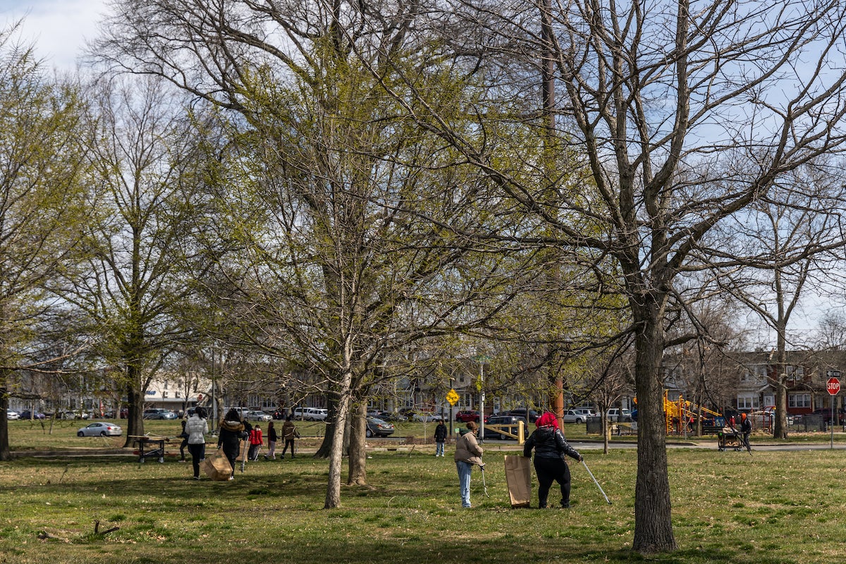 A spring clean-up takes place in Hunting Park a few days before the official start of the season. (Kimberly Paynter/WHYY)