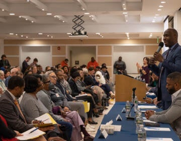 Students look on as mayoral candidates answer questions at a forum.