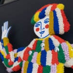 A tufted carnival figure is shown.