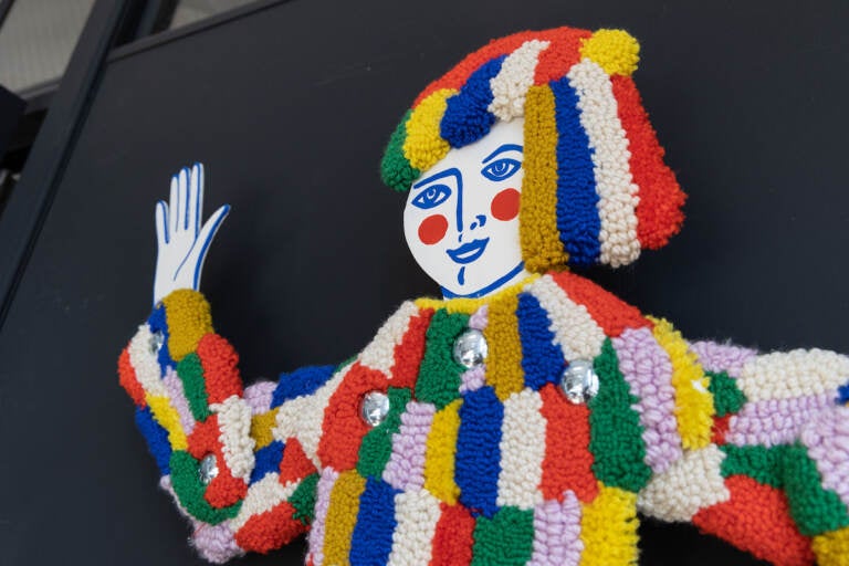 A tufted carnival figure is shown.