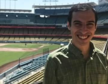 mathematician Ben Zauzmer poses at a stadium