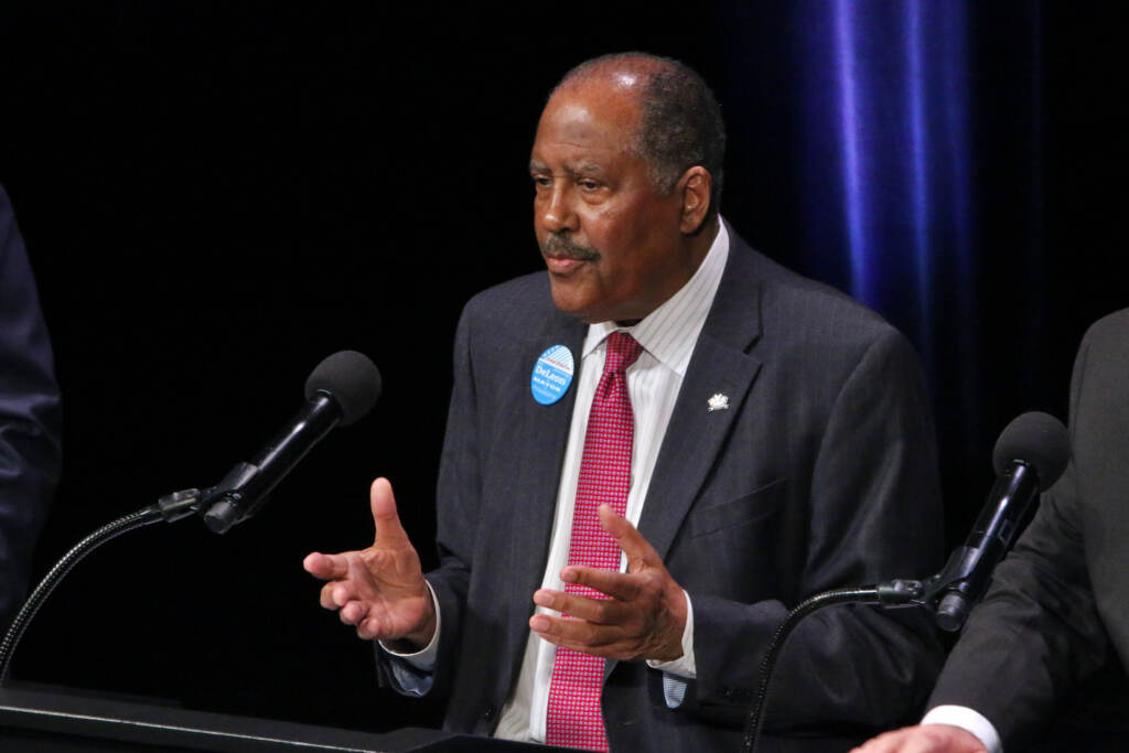 Jimmy DeLeon speaks into a microphone.