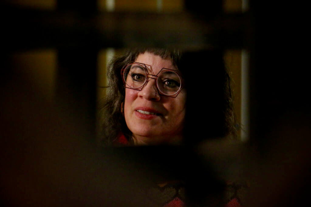 Jennifer-Navva Milliken looks through the latticework of a mashrabiya art exhibit.