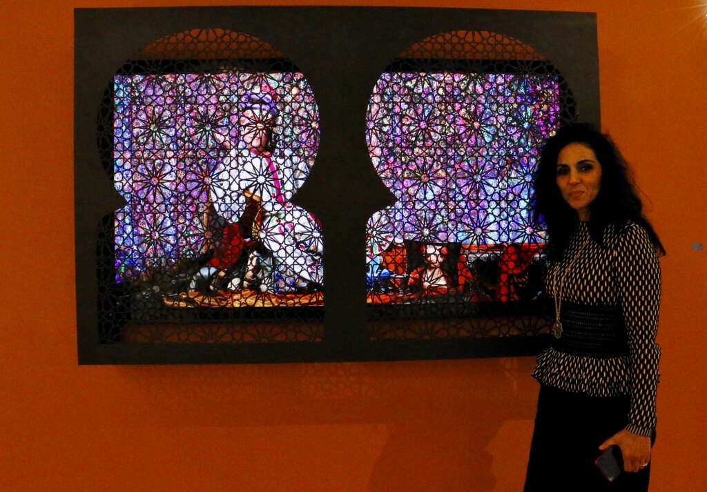 Majida Khattari stands next to her mashrabiya artwork.