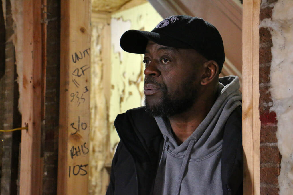 Dawud Bey stands in an unfinished apartment, one of 17 in his four-story building. At least 51 perceent of the units will be leased at below market rents to satisfy his commitment to providing affordable housing