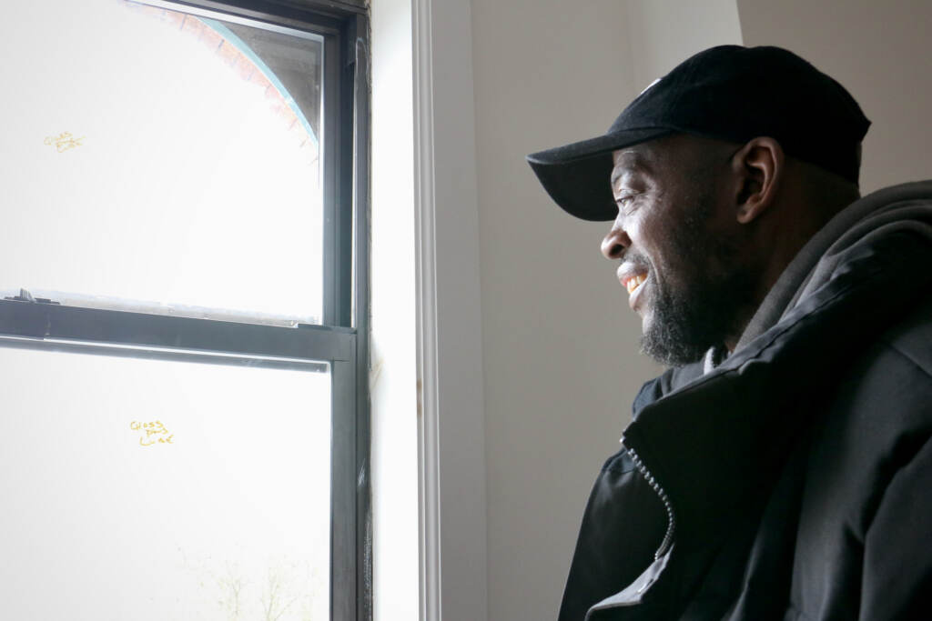 Dawud Bey grins as he takes in the view from the four-story apartment building he recently acquired overlooking Fairmount Park. He was able to take on the $2.7 million project with the help of the Philadelphia Accelerator Fund