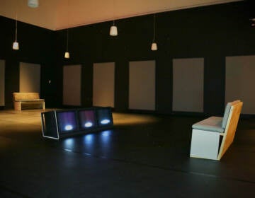 Carolyn Lazard,'s immersive exhibit, ''Long Take'' takes place in a darkened dance studio at the Institute of Contemporary Art. The sounds of dancing and verbal descriptions of the movements play from speakers while related words flash on and off on a trio of video screens. (Emma Lee/WHYY)