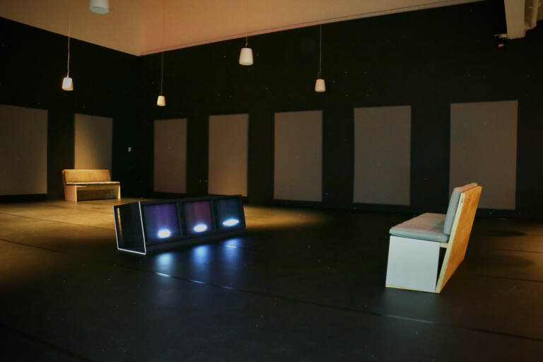 Carolyn Lazard,'s immersive exhibit, ''Long Take'' takes place in a darkened dance studio at the Institute of Contemporary Art. The sounds of dancing and verbal descriptions of the movements play from speakers while related words flash on and off on a trio of video screens. (Emma Lee/WHYY)