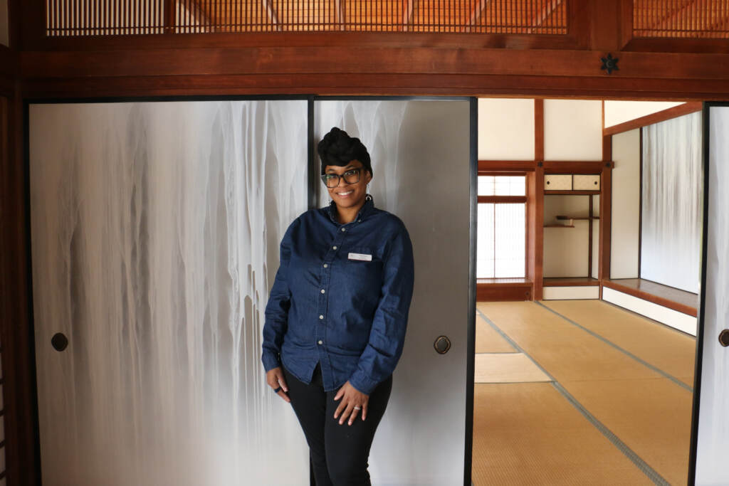 Candice Graham stands next to a repaired panel in Shofuso House.