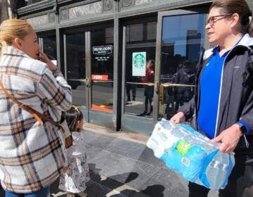 Residents could be seen carrying water through the streets of Philadelphia after the city recommend people start using bottled water starting at 2 p.m. on Sunday