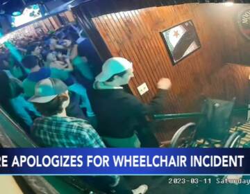 Video camera footage shows students throwing a wheelchair down the stairs at a bar.