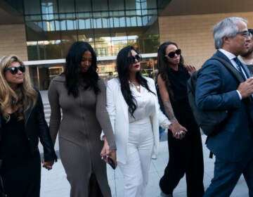 Vanessa Bryant (center) Kobe Bryant's widow, leaves a federal courthouse with her daughter Natalia (center left) soccer player Sydney Leroux (center right) in Los Angeles