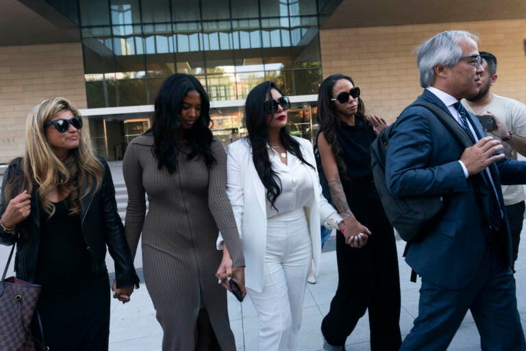 Vanessa Bryant (center) Kobe Bryant's widow, leaves a federal courthouse with her daughter Natalia (center left) soccer player Sydney Leroux (center right) in Los Angeles