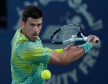 Serbia's Novak Djokovic returns the ball to Daniil Medvedev during their semi final match of the Dubai Duty Free Tennis Championships in Dubai