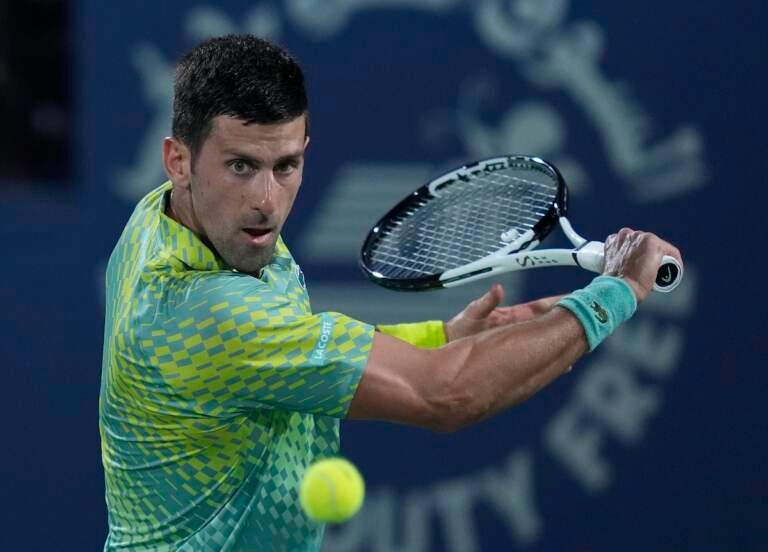 Serbia's Novak Djokovic returns the ball to Daniil Medvedev during their semi final match of the Dubai Duty Free Tennis Championships in Dubai