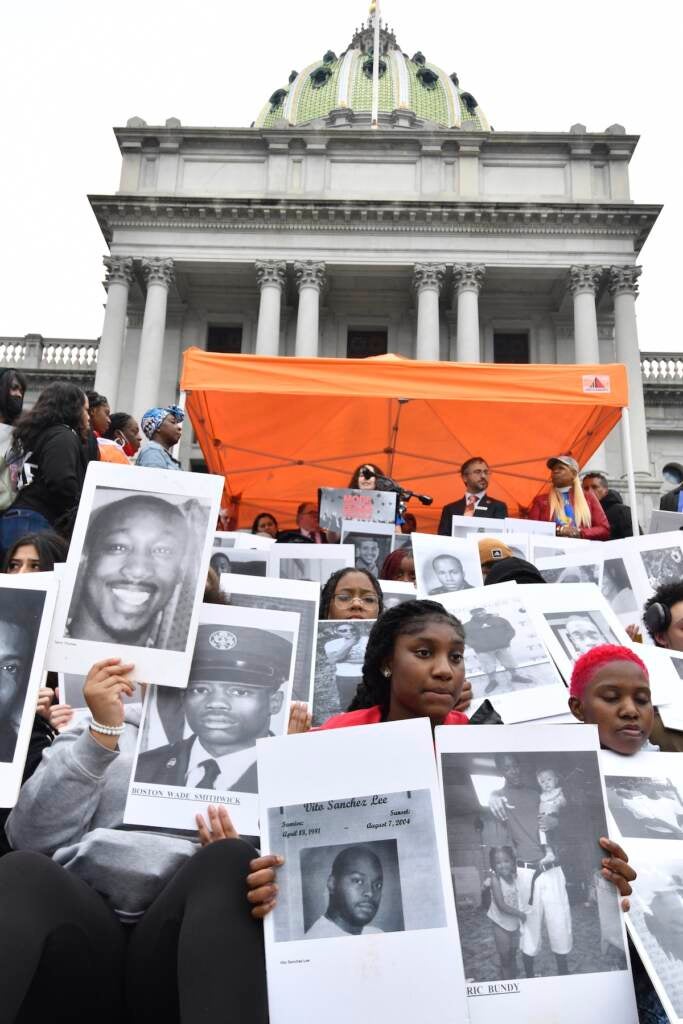 Students from Philadelphia hold photos of gun violence victims at a rally at the Pennsylvania Capitol pressing for stronger gun-control laws, Thursday, March 23, 2023, in Harrisburg, Pa. (AP Photo/Marc Levy)