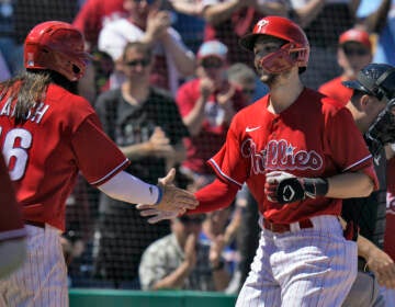 Philadelphia Phillies' Trea Turner shakes hands with Brandon Marsh (16) after Turner hit a two-run home run off Detroit Tigers' Joey Wentz during the fifth inning of a spring training baseball game Thursday, March 23, 2023, in Clearwater