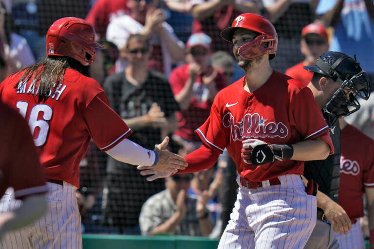Philadelphia Phillies' Trea Turner shakes hands with Brandon Marsh (16) after Turner hit a two-run home run off Detroit Tigers' Joey Wentz during the fifth inning of a spring training baseball game Thursday, March 23, 2023, in Clearwater