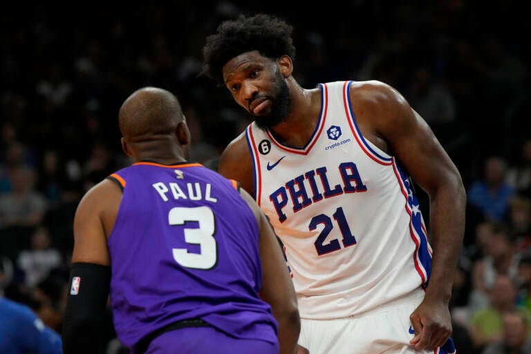 Phoenix Suns guard Chris Paul (3) and Philadelphia 76ers center Joel Embiid have words during the first half of an NBA basketball game Saturday, March 25, 2023, in Phoenix