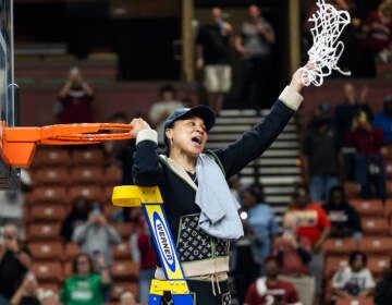 South Carolina head coach Dawn Staley celebrates with the net after defeating Maryland in an Elite 8 college basketball game of the NCAA Tournament in Greenville