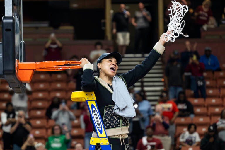 South Carolina head coach Dawn Staley celebrates with the net after defeating Maryland in an Elite 8 college basketball game of the NCAA Tournament in Greenville