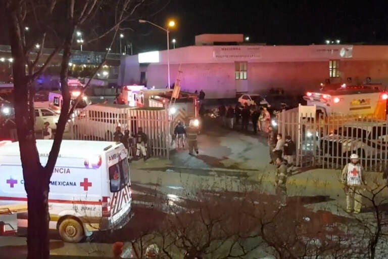Image taken from a video showing ambulances and rescue teams staffers outside an immigration center in Ciudad Juarez, Mexico