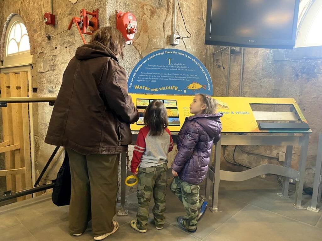 Maureen McGuigan and her daughters Asiadora (left), and Mirabell (right) at the Water and Wildlife Exhibit at the Fairmount Water Works Interpretive Center