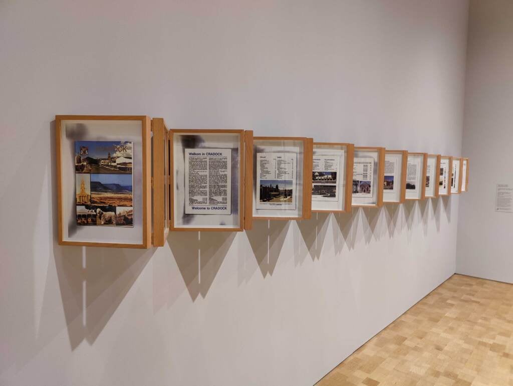 This wall installation is ''A Tale of Two Cradocks,'' by Sue Williamson, with pages describing the life of Mathew Goniwe, an anti-apartheid activist killed in 1985, with pages from an official tour guide of Cradock that makes no mention of the neighborhood where Goniwe lived