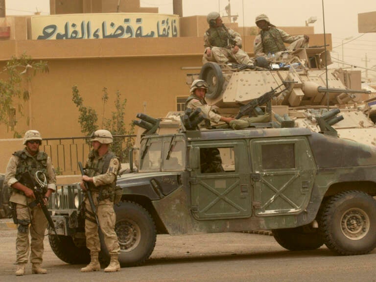 U.S. soldiers stand guard in Fallujah, May 2003. Congress will vote on whether to repeal the authorization for the use of military force orders passed in 1991 and in 2002 for two separate armed conflicts in Iraq. (Murad Sezer/Associated Press)