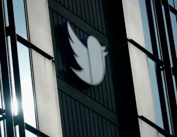 A Twitter logo hangs outside the company's offices in San Francisco