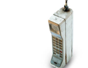 Close up rustic vintage mobile phone isolated on white background