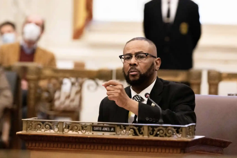 Curtis Jones sits at his desk in City Council Chambers